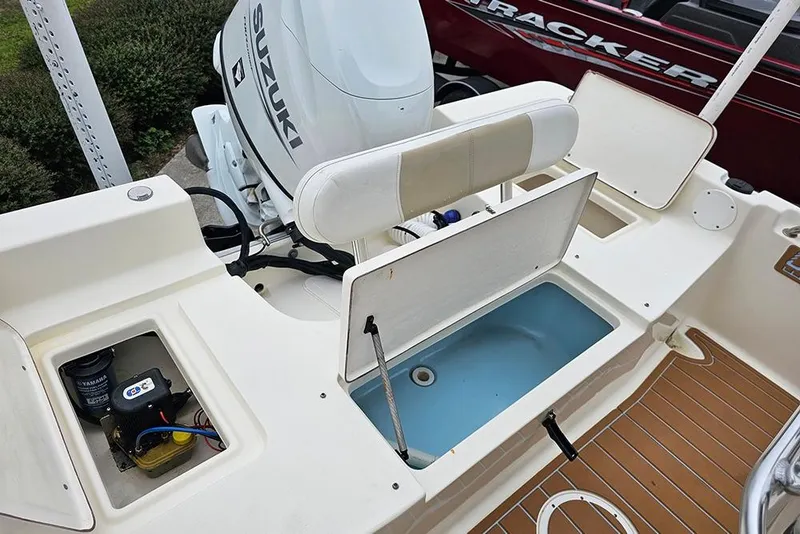 Slide: The Image of 2022 Bulls Bay 2000 boat interior with Suzuki engine and storage compartments. - 10