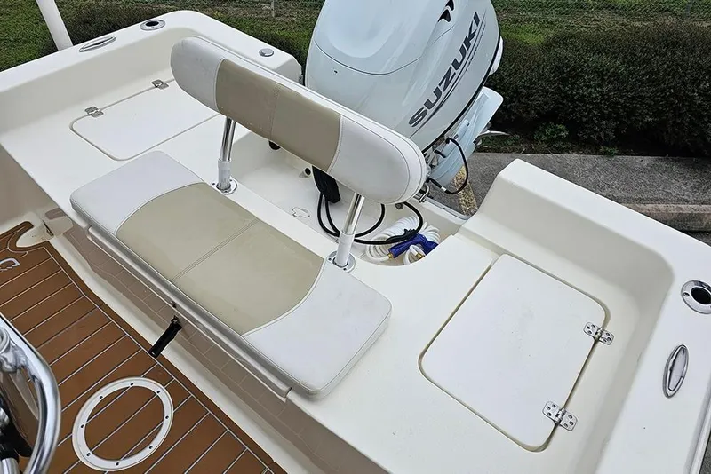 Slide: The Image of 2022 Bulls Bay 2000 boat interior with seating and Suzuki outboard motor. - 11