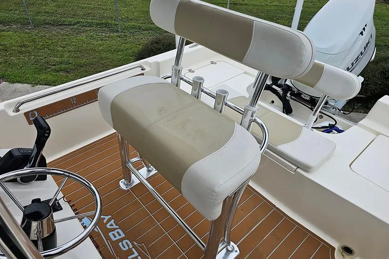 Slide: The Image of Bulls Bay 2000 boat interior, featuring beige seating and steering wheel, 2022 model. - 12