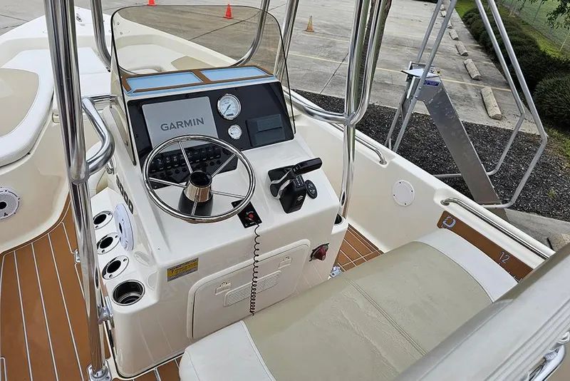 Slide: The Image of Bulls Bay 2000 boat console with Garmin system, 2022 model, featuring steering and controls. - 13
