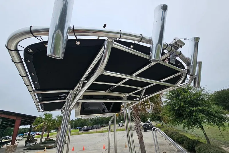 Slide: The Image of Bulls Bay 2000 boat T-top with rod holders, 2022 model, in a scenic outdoor setting. - 14