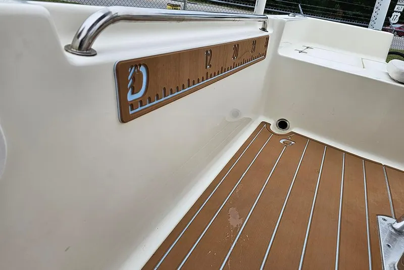 Slide: The Image of Interior view of a 2022 Bulls Bay 2000 boat with teak flooring and a measuring board. - 21
