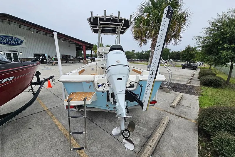 Slide: The Image of 2022 Bulls Bay 2000 boat with outboard motor, parked outdoors near dealership. - 8