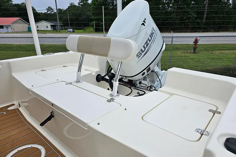 Slide: The Image of 2022 Bulls Bay 2000 boat with Suzuki outboard motor, featuring a white deck and seating. - 9