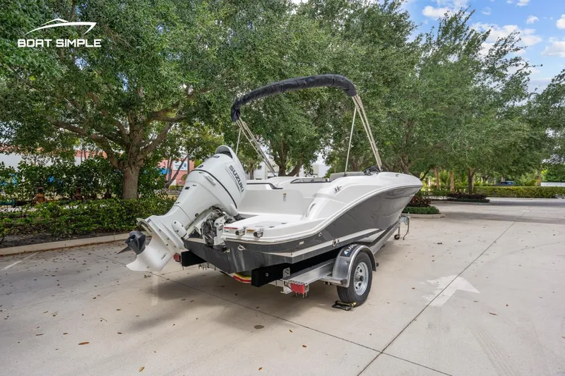 Slide: The Image of 2021 Hurricane SunDeck Sport 205 OB boat on trailer, parked outdoors. - 6