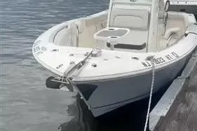 Slide: The Image of 2024 Sailfish 241 CC boat docked on calm water. - 4