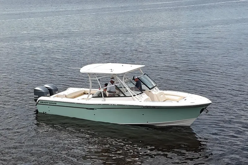 The Image of 2015 Grady-White Freedom 285 boat on calm water, featuring dual outboard motors. - 0