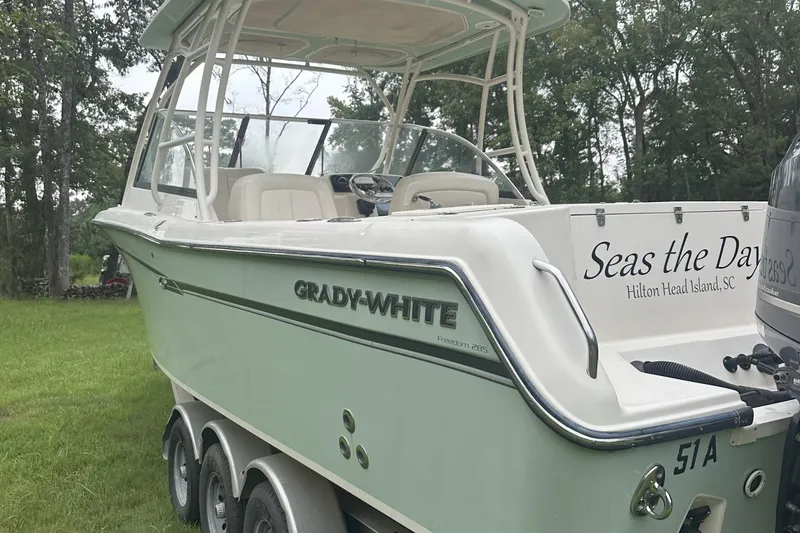 Slide: The Image of 2015 Grady-White Freedom 285 boat on trailer, "Seas the Day" inscription. - 3
