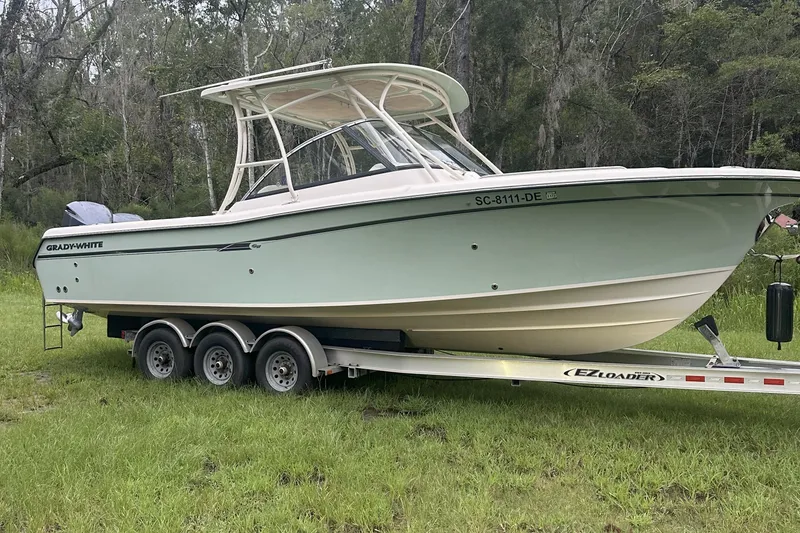 Slide: The Image of 2015 Grady-White Freedom 285 boat on trailer in grassy area. - 4