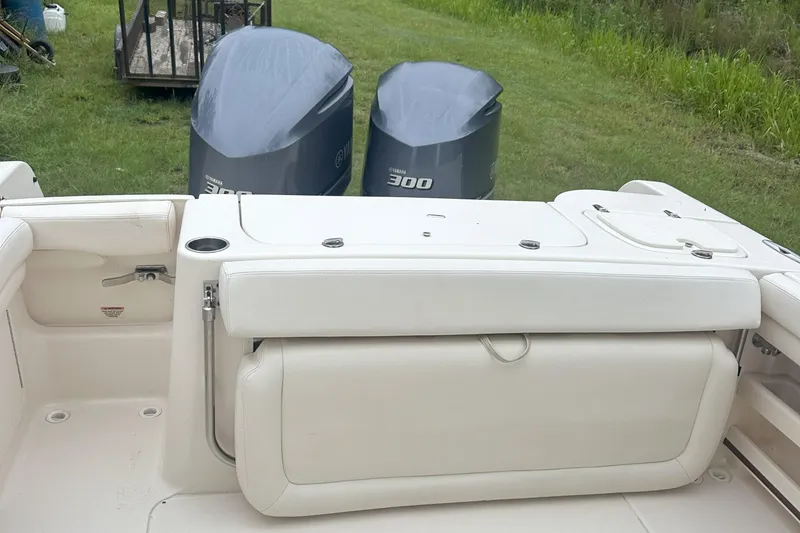 Slide: The Image of 2015 Grady-White Freedom 285 boat with dual Yamaha 300 engines, white seating, grassy background. - 9