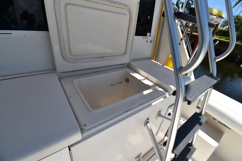 Slide: The Image of 1997 Tiara 4300 boat interior with open storage compartment and ladder. - 10