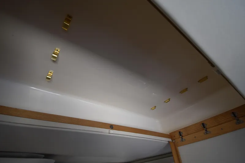 Slide: The Image of Interior ceiling of 1997 Tiara 4300 boat with wooden trim and gold fixtures. - 13