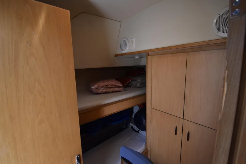 Slide: The Image of Cozy cabin interior of 1997 Tiara 4300 yacht with wooden storage and bedding. - 14