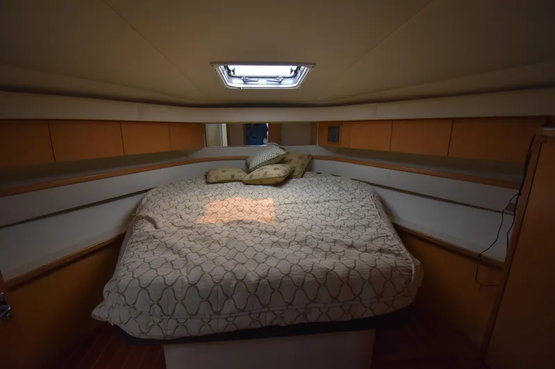 Slide: The Image of Mainstate room 1997 Tiara 4300 yacht with a comfortable bed and soft lighting. - 16