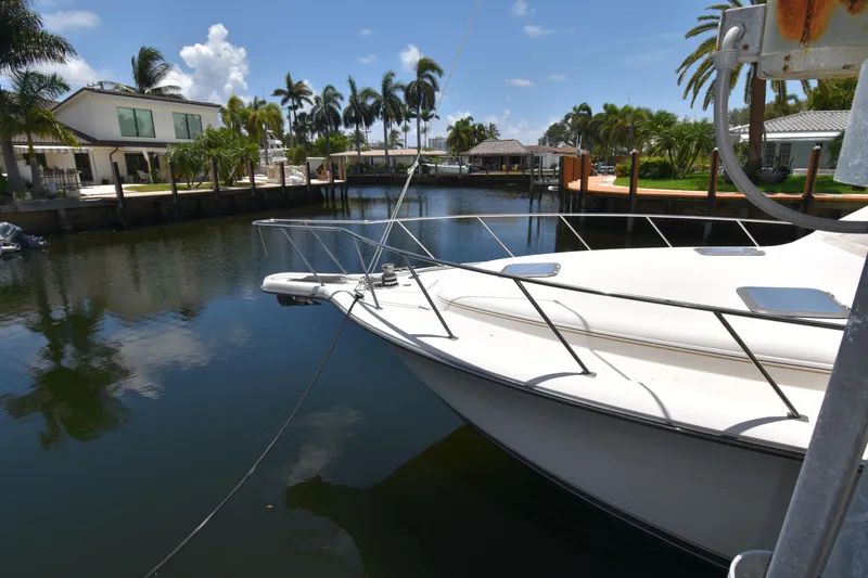 Slide: The Image of Tiara 4300 yacht docked in a scenic canal, surrounded by palm trees and luxury homes. - 2