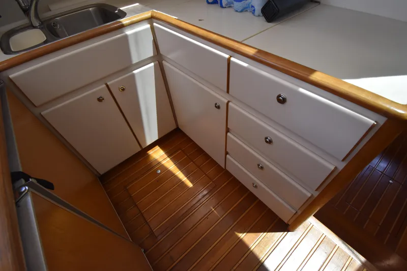Slide: The Image of 1997 Tiara 4300 yacht interior with wooden flooring and white cabinetry. - 23
