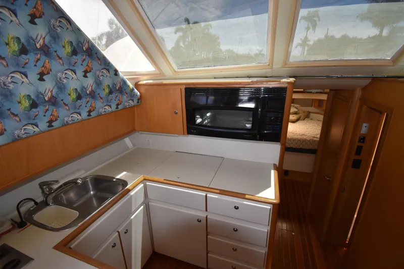 Slide: The Image of Interior of 1997 Tiara 4300 yacht kitchen with skylight, sink, and microwave. - 24