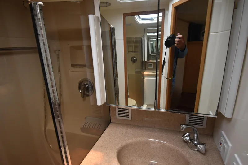 Slide: The Image of Bathroom interior of 1997 Tiara 4300 yacht with mirrored cabinet and sink. - 25