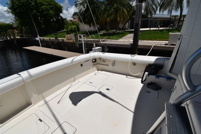 Slide: The Image of Spacious deck of a 1997 Tiara 4300 yacht docked by lush greenery. - 27