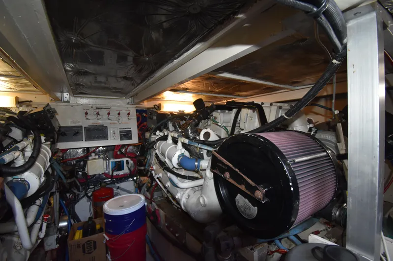 Slide: The Image of Engine room of a 1997 Tiara 4300 boat, showcasing mechanical components and controls. - 29