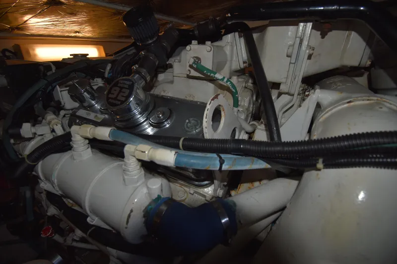 Slide: The Image of Engine compartment of a 1997 Tiara 4300 boat, showcasing mechanical components and wiring. - 31