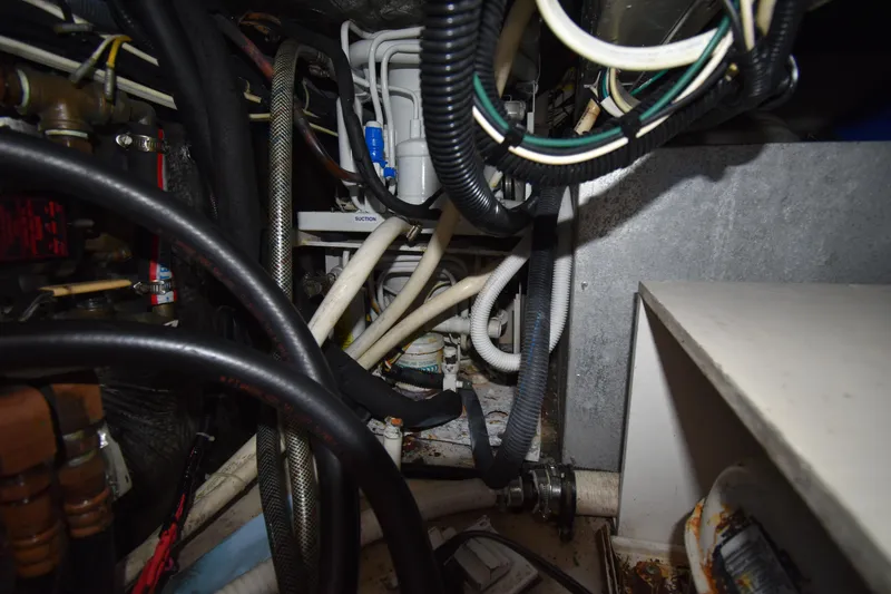 Slide: The Image of Engine compartment of a 1997 Tiara 4300, showcasing complex wiring and hoses. - 33