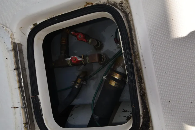 Slide: The Image of Boat compartment with valves and hoses, Tiara 4300, 1997 model. - 36