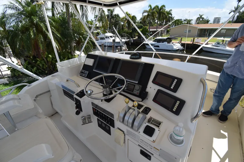 Slide: The Image of Helm of 1997 Tiara 4300 yacht with navigation equipment and controls. - 43