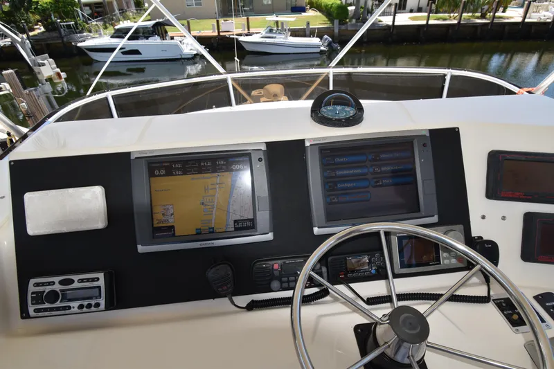 Slide: The Image of 1997 Tiara 4300 yacht helm with navigation screens and steering wheel. - 6