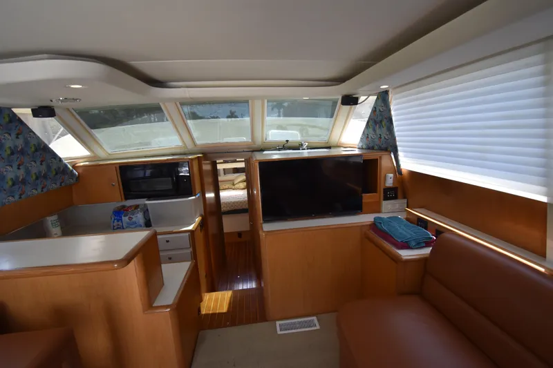 Slide: The Image of Interior of a 1997 Tiara 4300 yacht with modern amenities and cozy seating. - 8