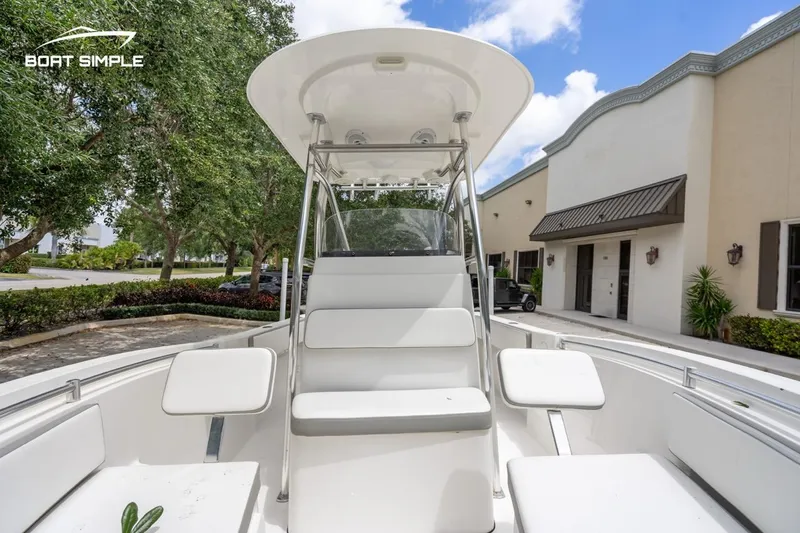 Slide: The Image of 2020 Release 210 RX boat with seating, outdoor setting, and clear sky. - 7