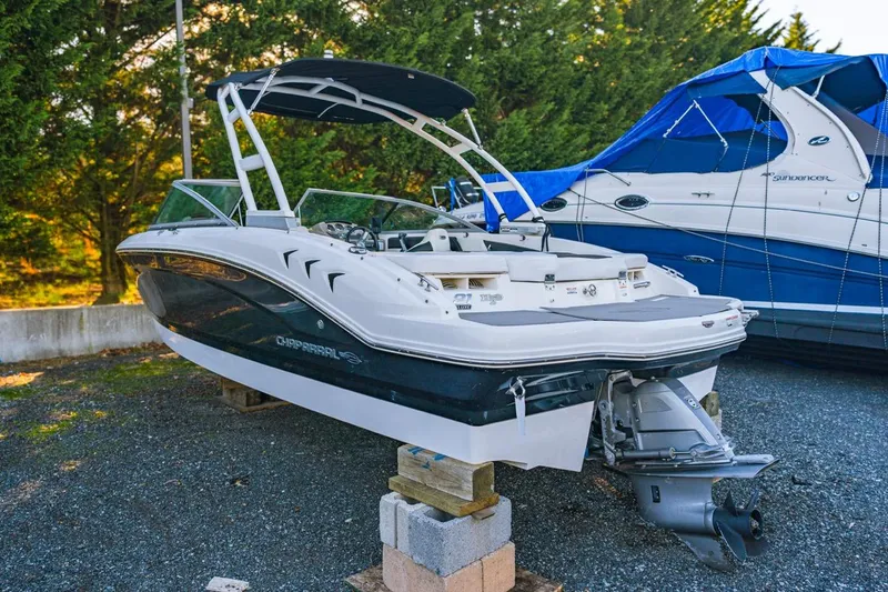 Slide: The Image of 2018 Chaparral 210 Suncoast boat on blocks, parked outdoors. - 4
