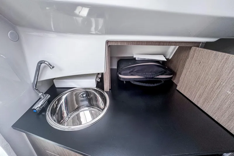 Slide: The Image of 2022 Beneteau America Flyer 8 Sundeck interior with sink and storage area. - 12