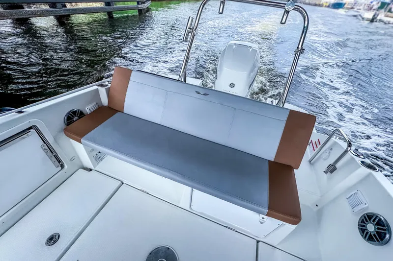 Slide: The Image of 2022 Beneteau America Flyer 8 Sundeck boat interior with cushioned seating and water view. - 14