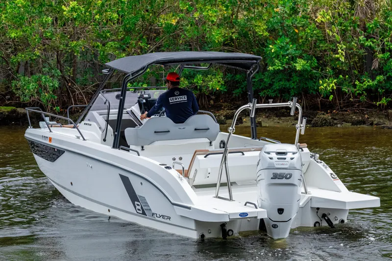 Slide: The Image of 2022 Beneteau America Flyer 8 Sundeck boat cruising on a calm river. - 5