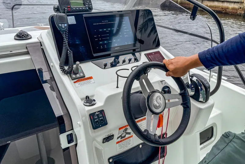 Slide: The Image of 2022 Beneteau America Flyer 8 Sundeck cockpit with steering wheel and navigation controls. - 8