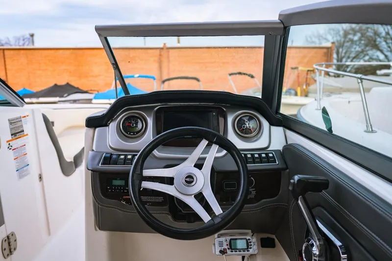 Slide: The Image of 2018 Chaparral 224 Sunesta boat dashboard with steering wheel and gauges. - 5