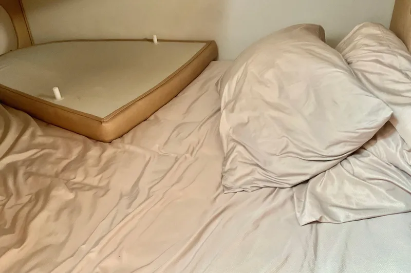 Slide: The Image of Interior cabin bed of 2013 Rinker 290 Express Cruiser with beige bedding. - 20