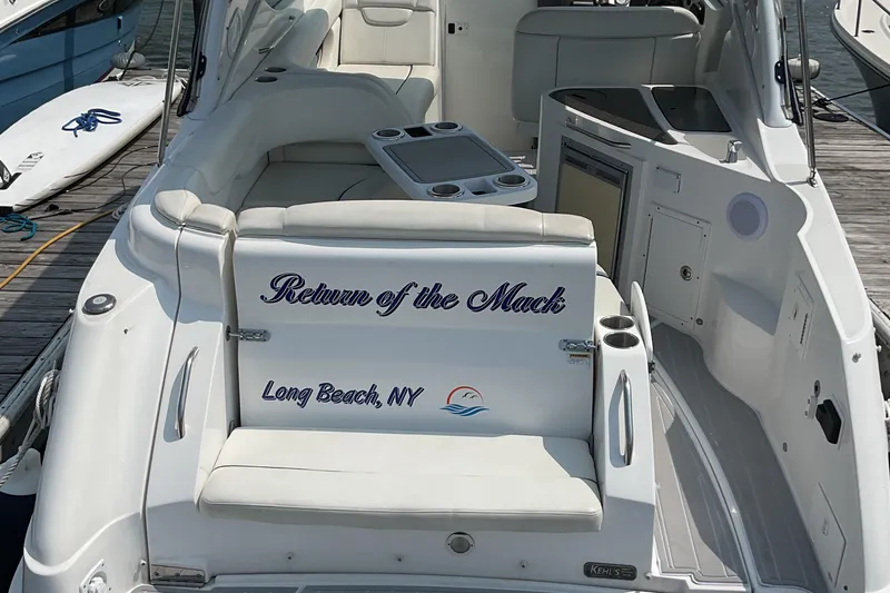 Slide: The Image of 2013 Rinker 290 Express Cruiser docked, featuring "Return of the Mack" text, Long Beach, NY. - 3