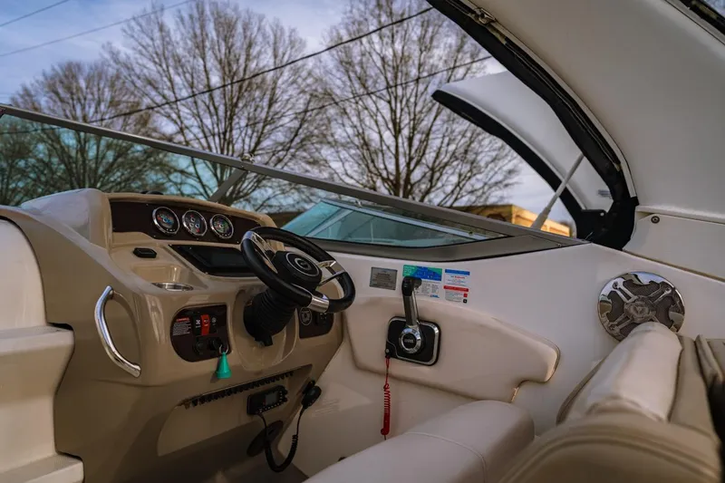 Slide: The Image of Interior view of 2018 Chaparral 270 Signature boat cockpit with steering wheel and controls. - 0
