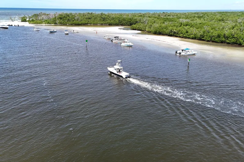 Slide: The Image of Aerial view of 2007 Pursuit OS 285 Offshore boat navigating coastal waters. - 14