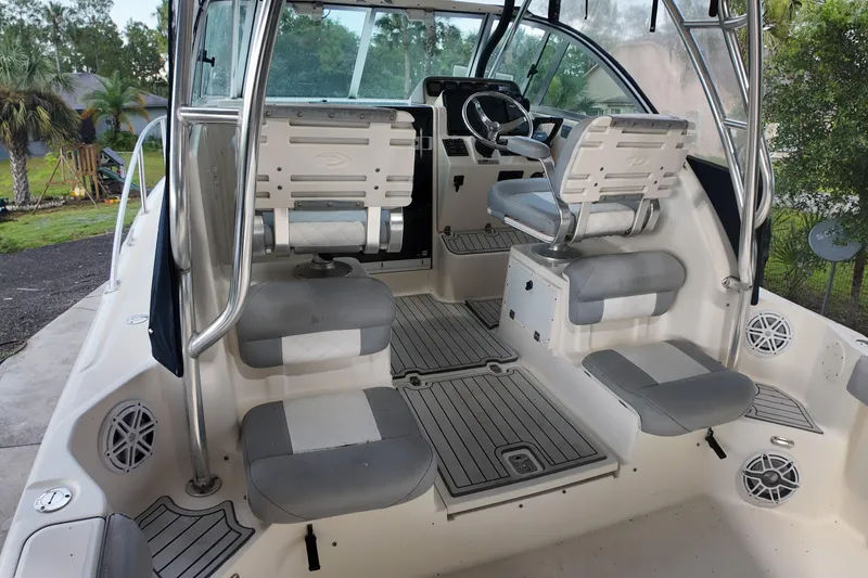 Slide: The Image of 2007 Pursuit 285 Offshore boat interior with seating and steering wheel, featuring sleek design. - 27