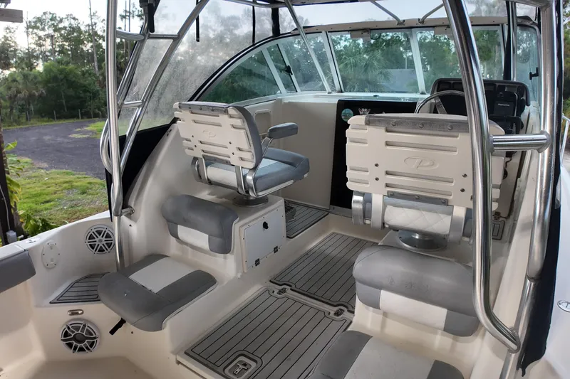 Slide: The Image of 2007 Pursuit 285 Offshore boat interior with seating and steering area. - 28