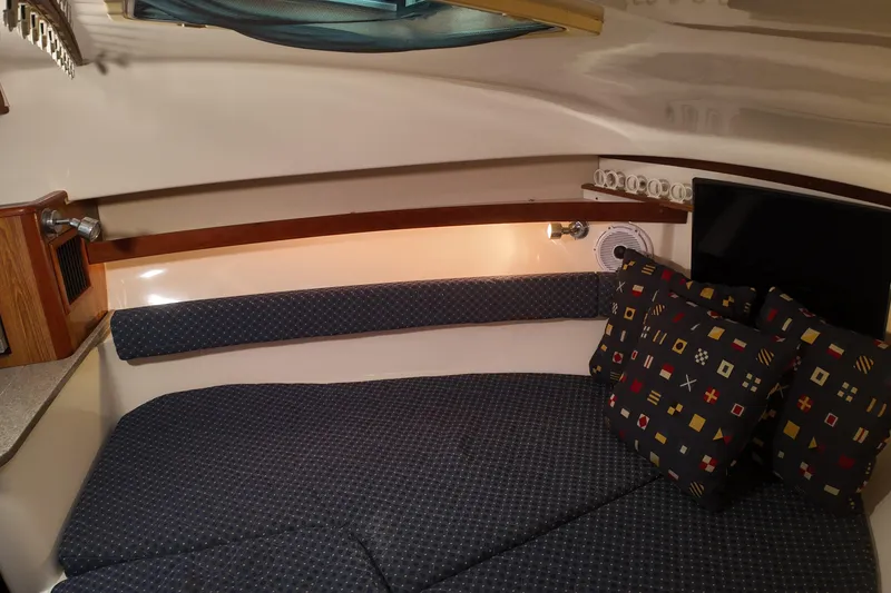 Slide: The Image of Cozy cabin interior of 2007 Pursuit 285 Offshore with patterned cushions and ambient lighting. - 33