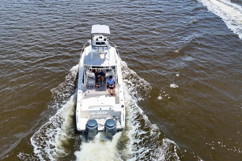 Slide: The Image of 2007 Pursuit OS 285 Offshore boat cruising on open water, aerial view. - 8