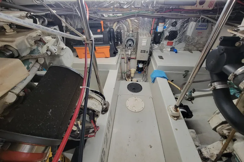 Slide: The Image of Engine room of a 1992 Mediterranean 38 boat, showcasing mechanical components and wiring. - 9