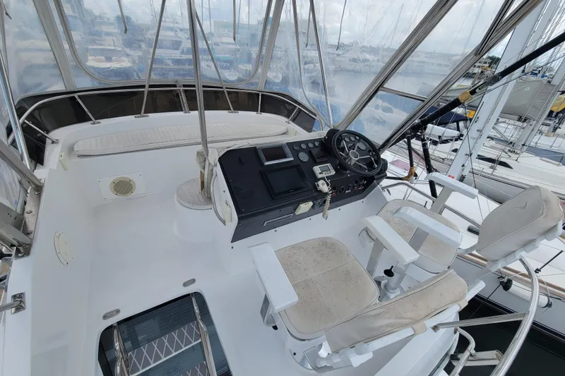 Slide: The Image of Cockpit of 1992 Mediterranean 38 yacht with steering wheel and navigation controls. - 12