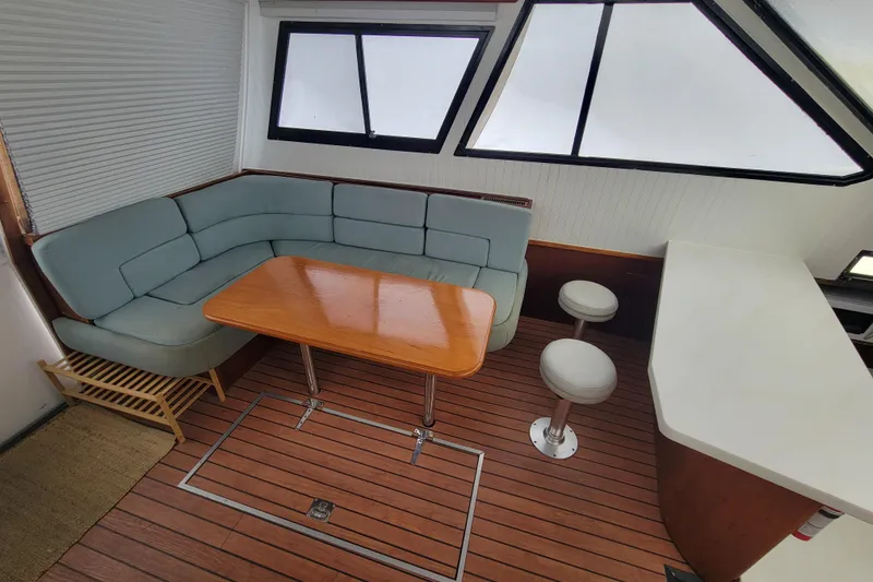 Slide: The Image of Interior of a 1992 Mediterranean 38 yacht with seating, table, and bar stools. - 2