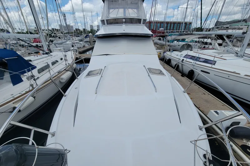 Slide: The Image of 1992 Mediterranean 38 yacht docked at marina, surrounded by sailboats under cloudy sky. - 11