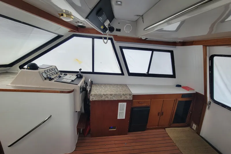 Slide: The Image of Interior of a 1992 Mediterranean 38 boat with helm and seating area. - 3